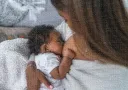 madre lactando con bebé en posición the cuna